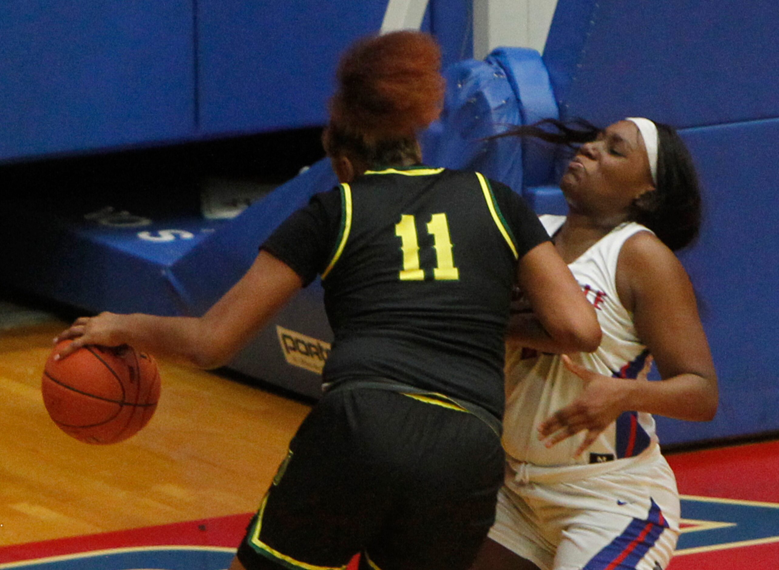 DeSoto's Tionna Herron (11), drives against Duncanville's Kenidi Glover (10) during first...