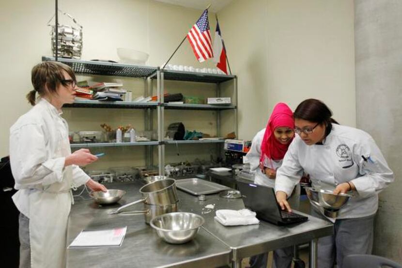 
Caleb Helms, Sumaya Mohamud (center) and Yatziri Bravo work in the culinary arts classroom...