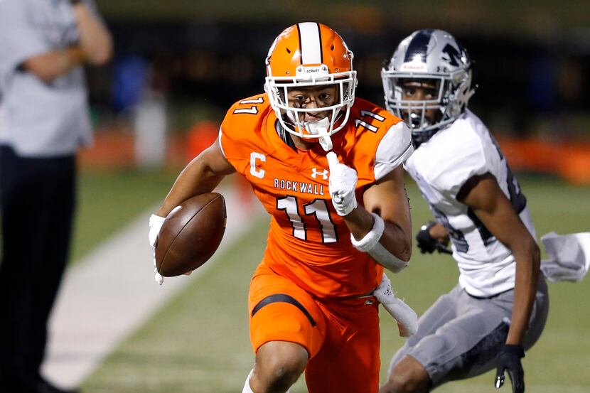 Rockwall's Jaxon Smith-Njigba (11) runs up the field after the catch in a game against...