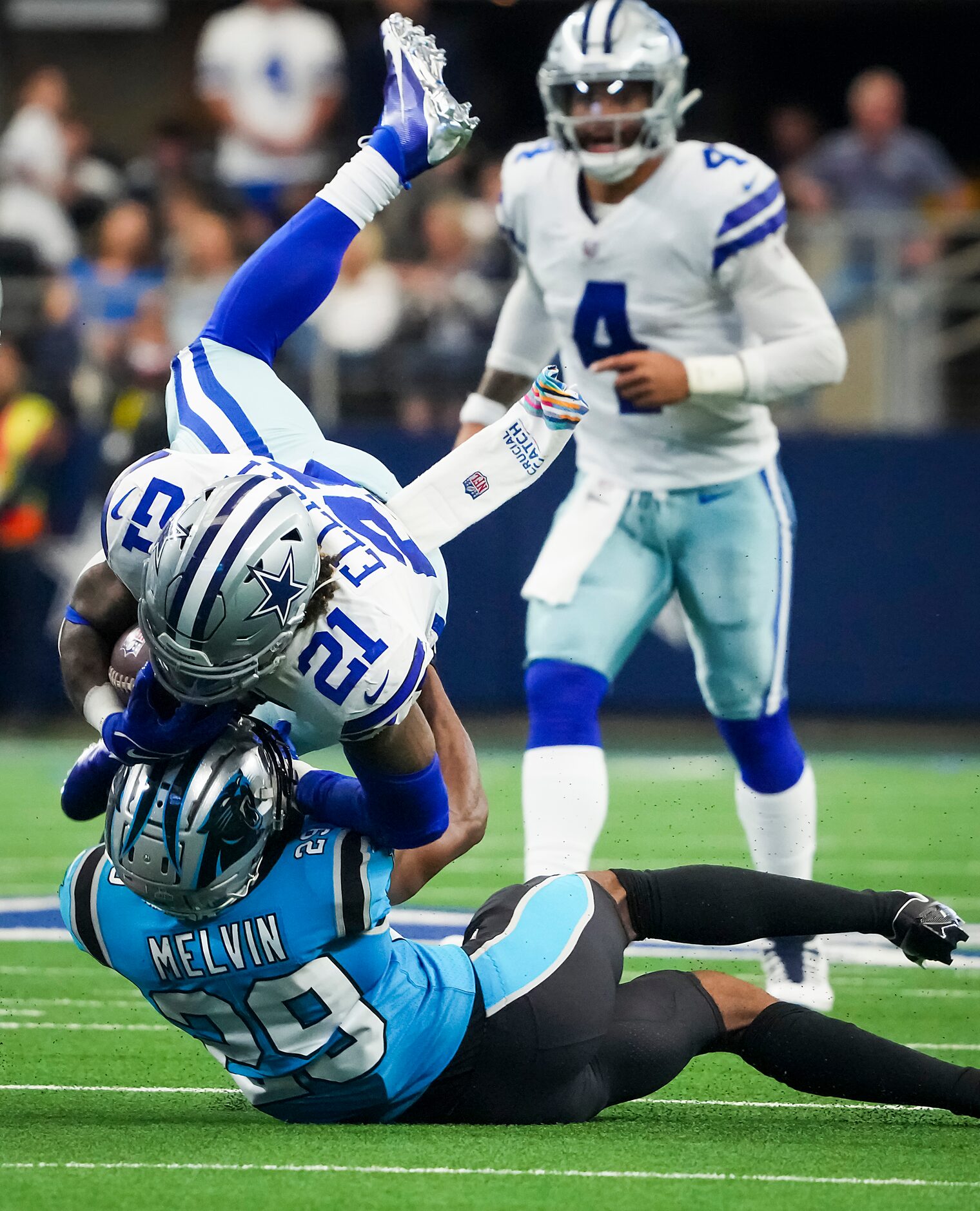 Dallas Cowboys running back Ezekiel Elliott (21) is brought down by Carolina Panthers...