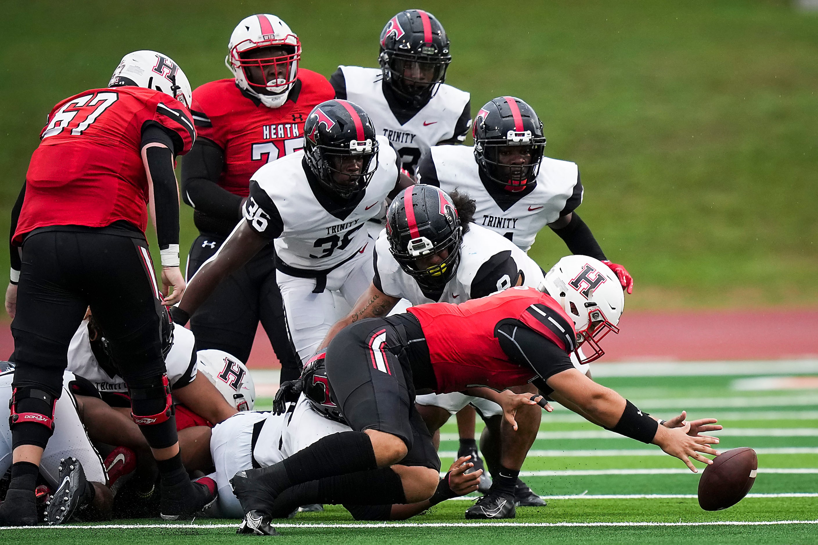 Rockwall-Heath quarterback Caleb Hoover (7) recovers a Hawks fumble during the first half of...