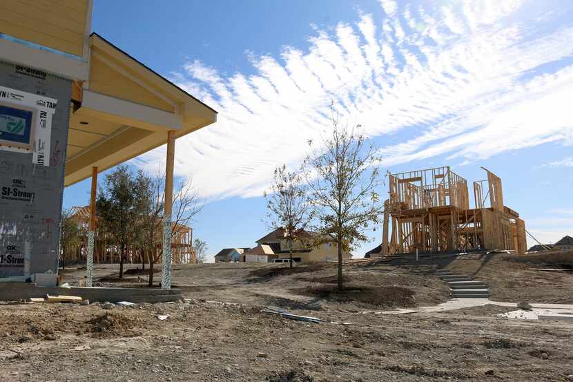 Construction crews work on homes under development at the Walsh Ranch in Fort Worth, TX.