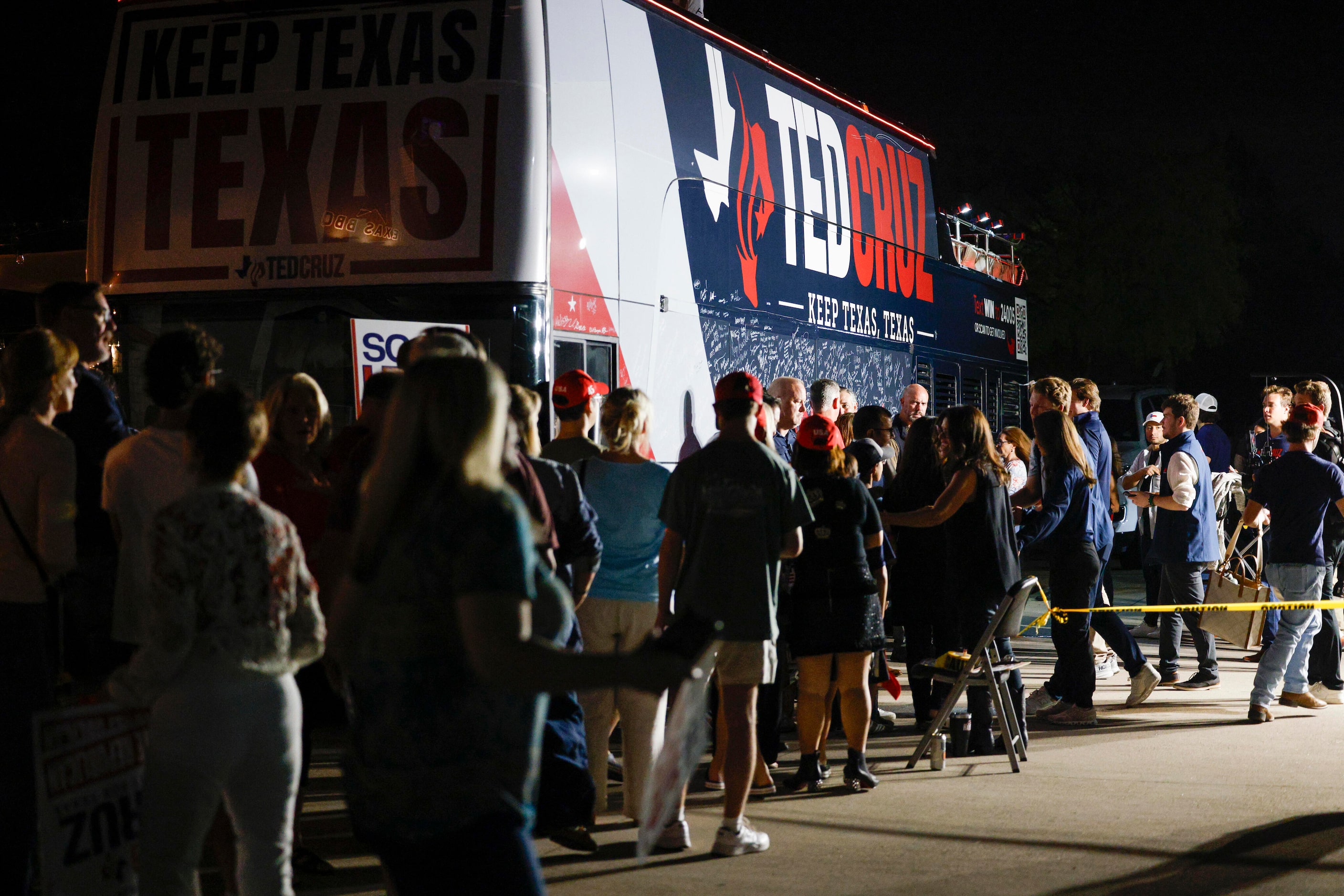 Dozens of people wait in line for photos with Senator Ted Cruz (R-Texas) after a campaign...