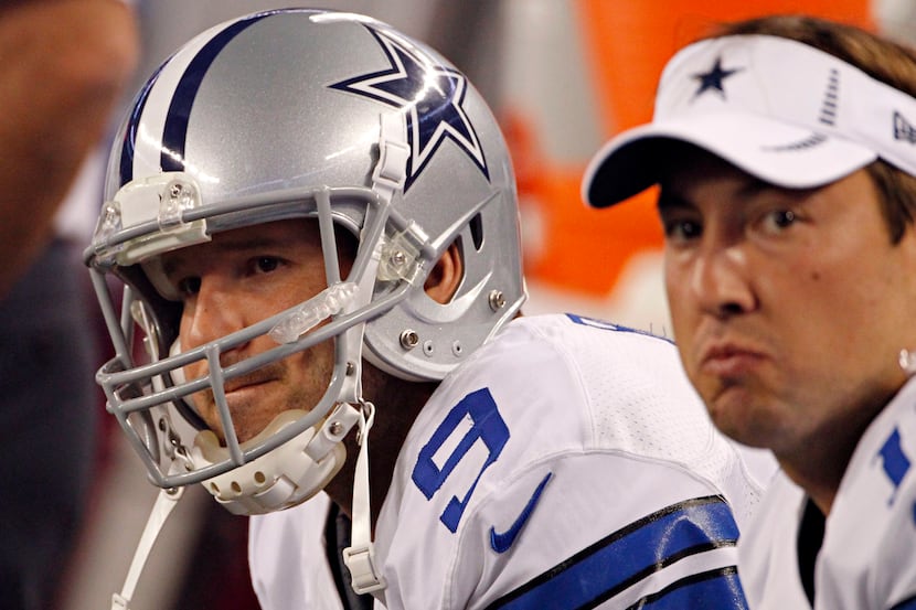Dallas Cowboys quarterback Tony Romo looks on from the sidelines after his tipped pass was...
