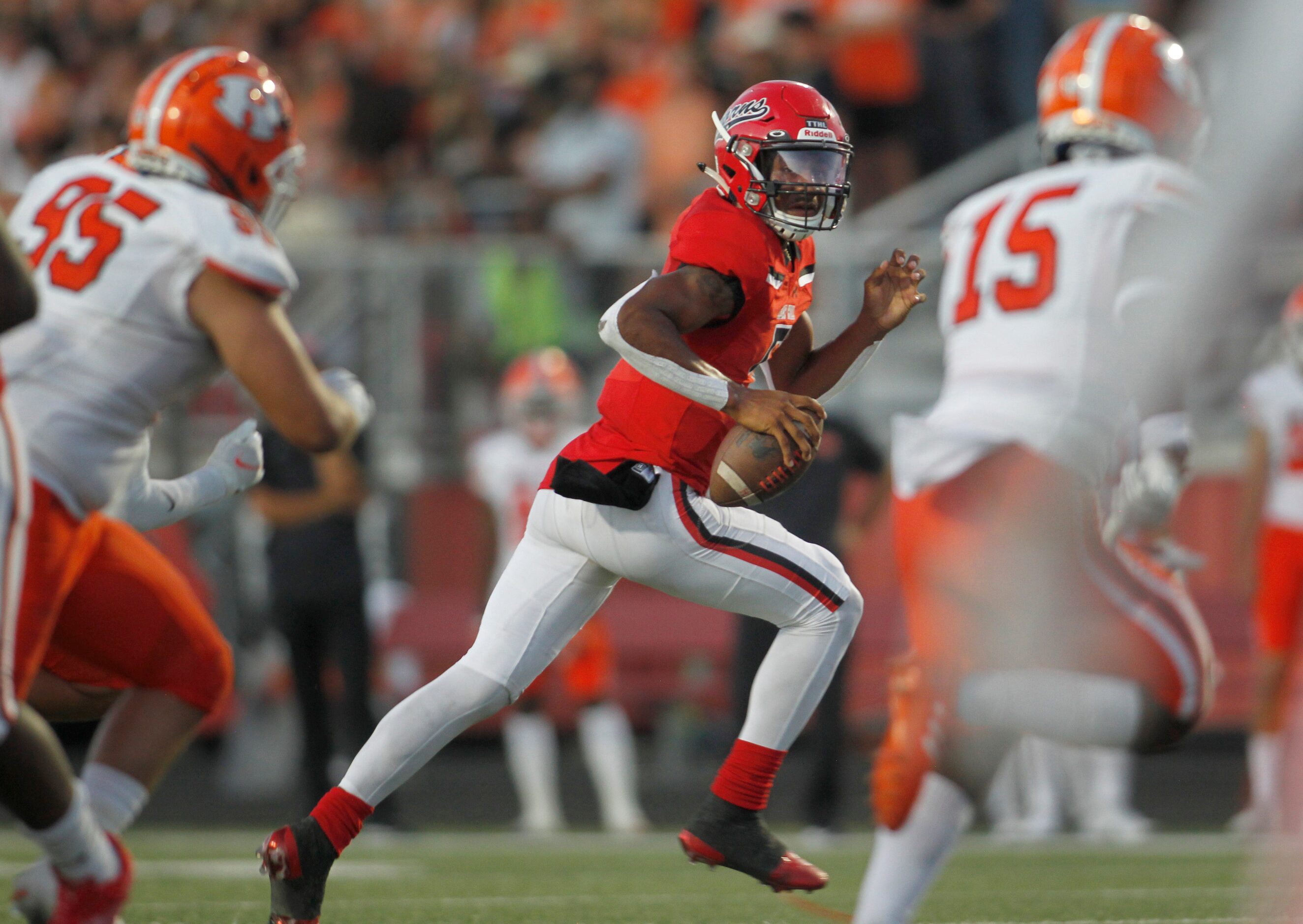 Cedar Hill quarterback Cedric Harden, Jr. (5) rolls out in search of a receiver as Rockwall...