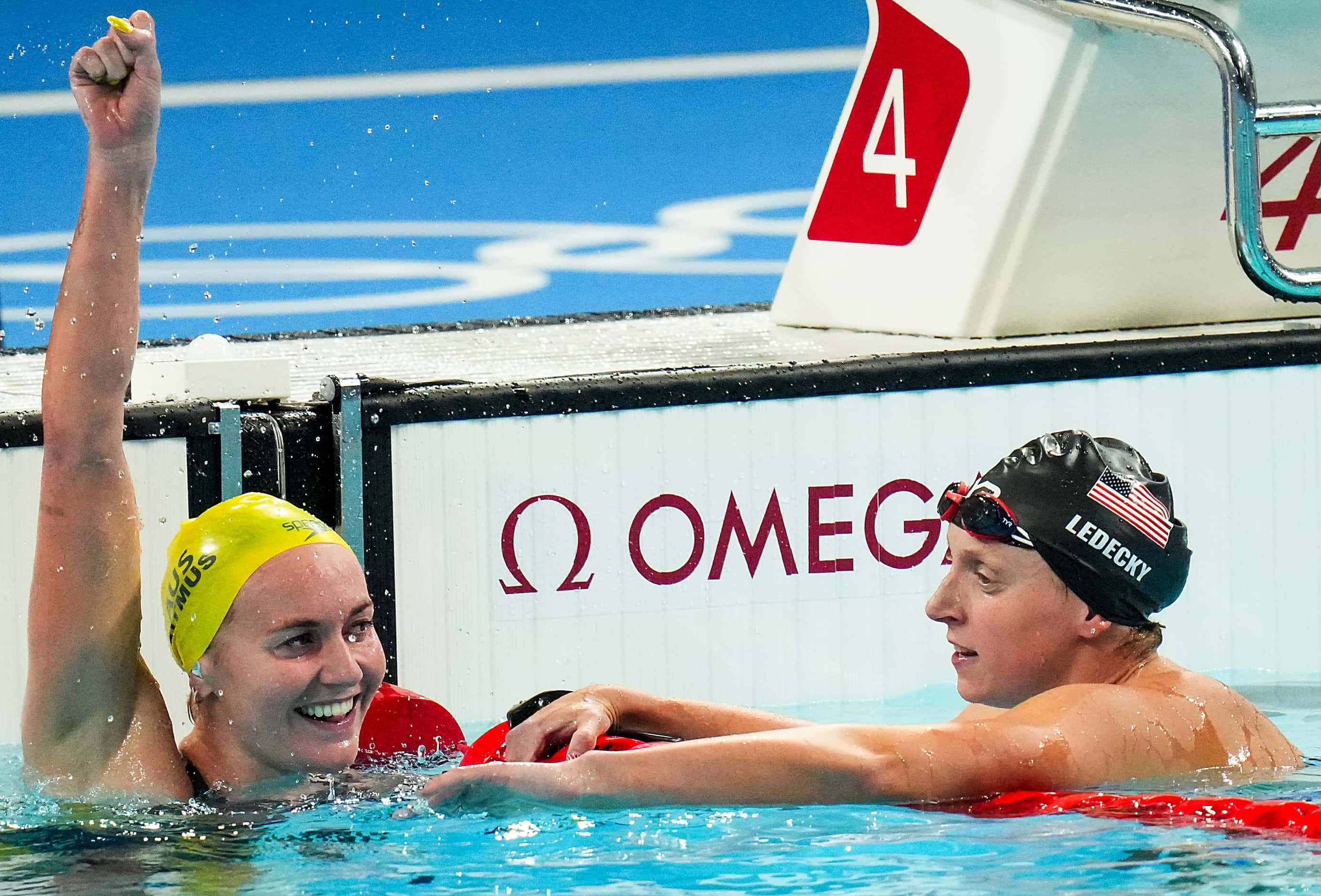 Ariarne Titmus of Australia (left) celebrates after winning the women's 400-meter freestyle...