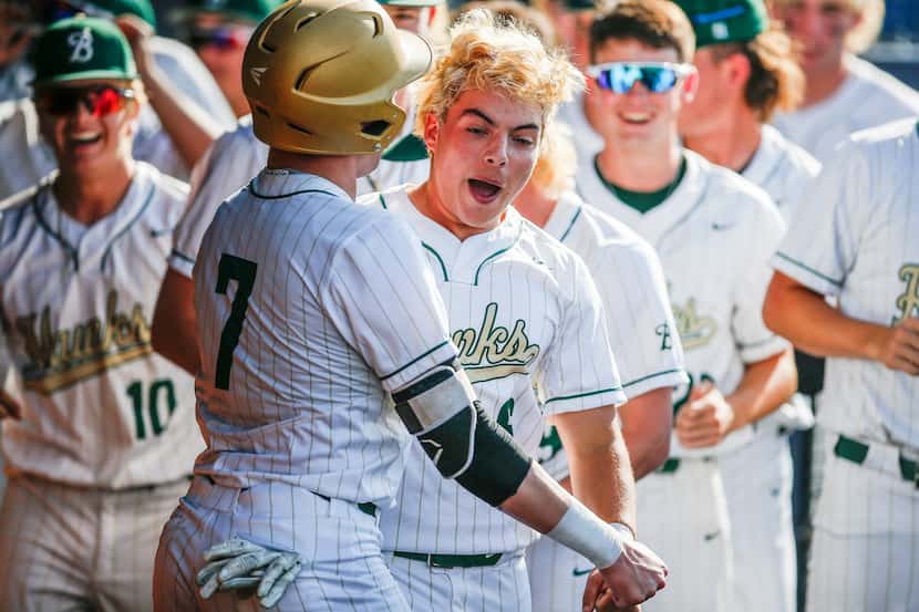 Birdville’s Bynum Martinez (6) is congratulated by teammates after scoring a run during the...