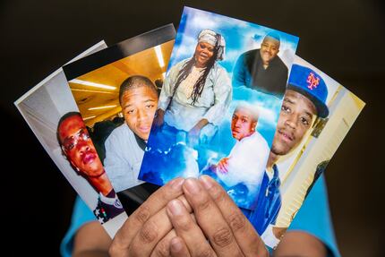 Nicole Hill holds several photos of deceased brothers Isaac (second from left) and Ishmael...