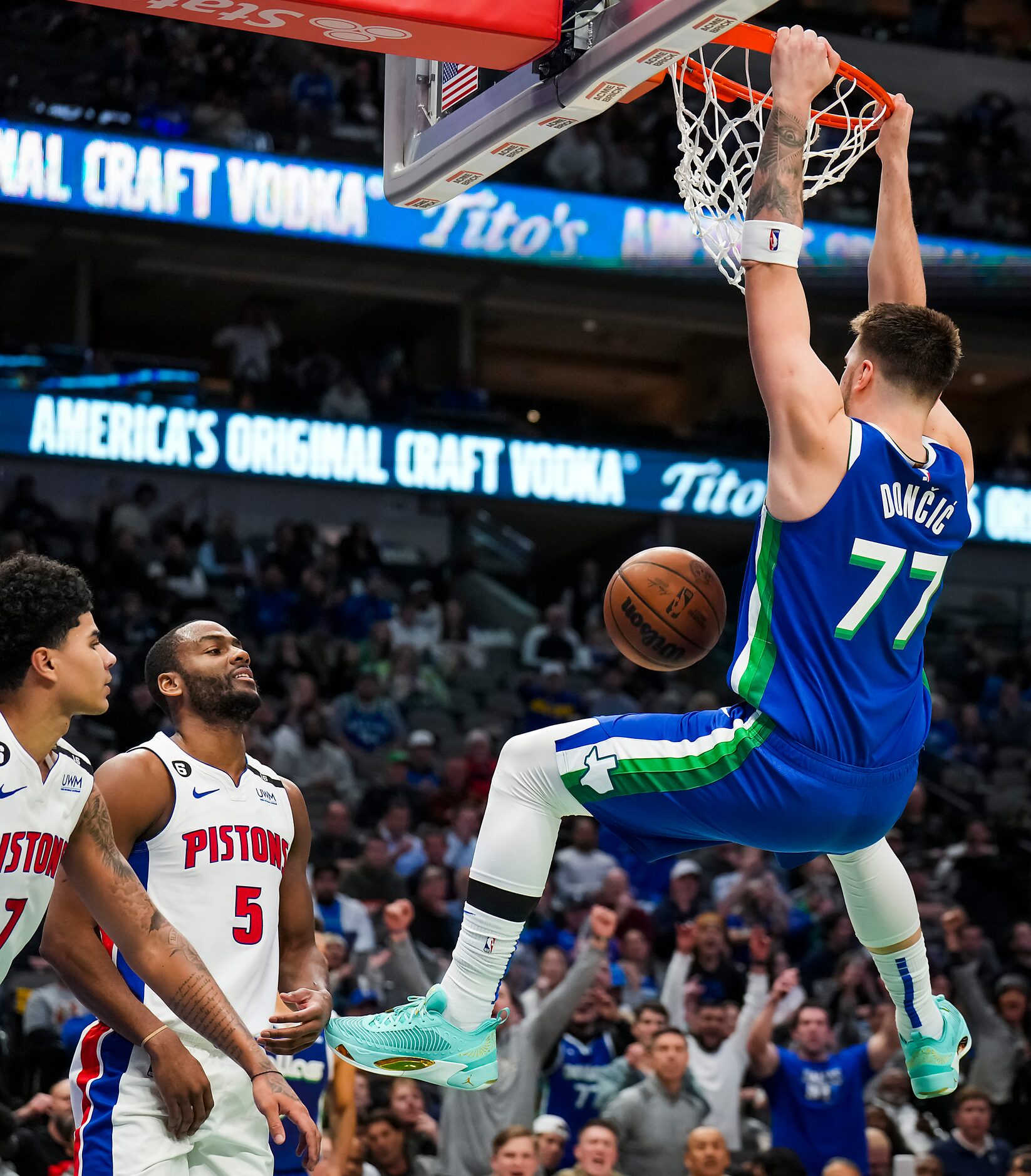 Dallas Mavericks guard Luka Doncic (77) dunks the ball past Detroit Pistons guard Killian...