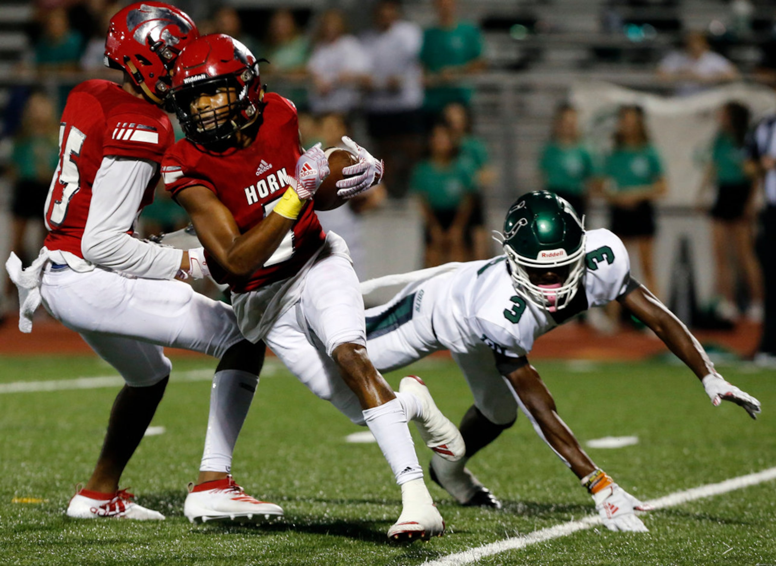 Mesquite Horn DB Evan Williams (5) returns an interception, as Arlington High's Lesley...