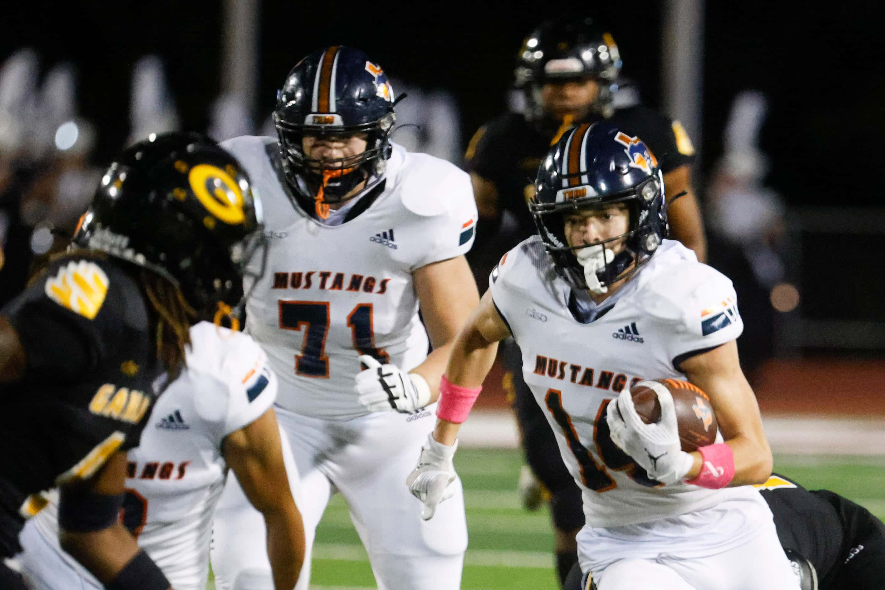 Sachse high school’s Robbie Rothrock (right) runs for a yardage against Garland High school...