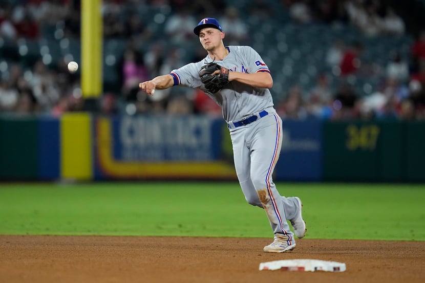 Texas Rangers shortstop Corey Seager (5) throws to first to out Los Angeles Angels' Brandon...