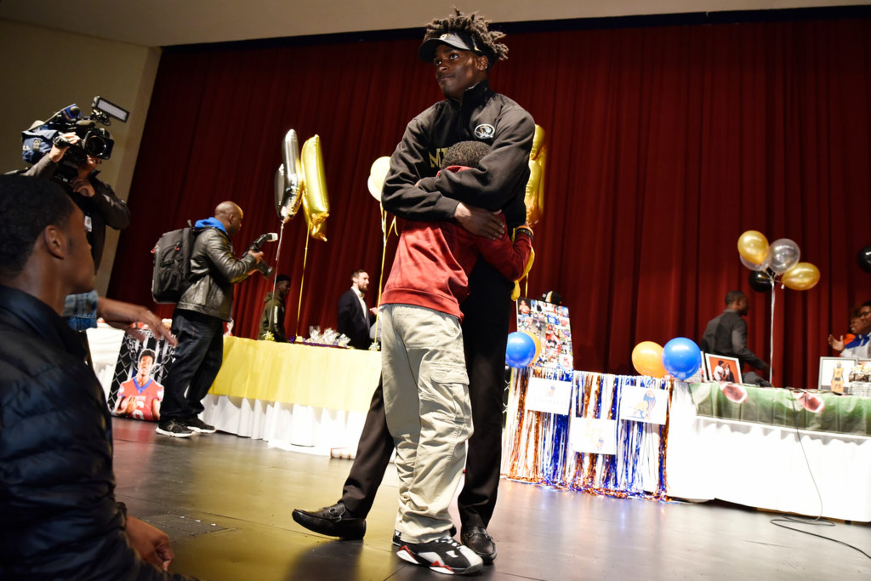 Duncanville cornerback Ennis Rakestraw, Jr., receives a huge from his younger brother Damion...