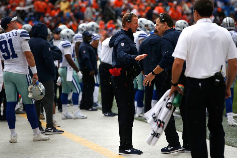 Dallas Cowboys head coach Jason Garrett speaks to Dallas Cowboys linebacker coach Matt...