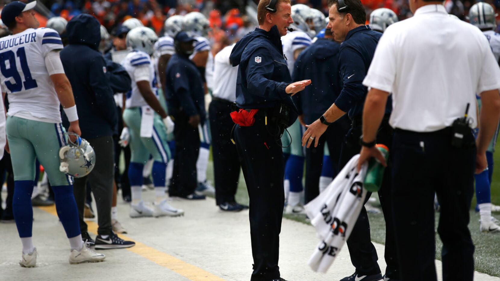 Dallas Cowboys head coach Jason Garrett speaks to Dallas Cowboys linebacker coach Matt...