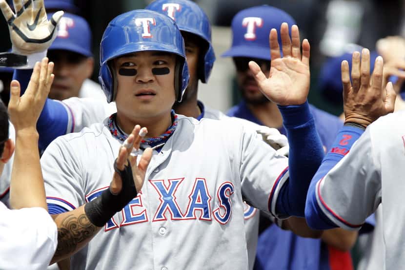 DETROIT, MI - MAY 22:  Shin-Soo Choo #17 of the Texas Rangers is congratulated in the dugout...