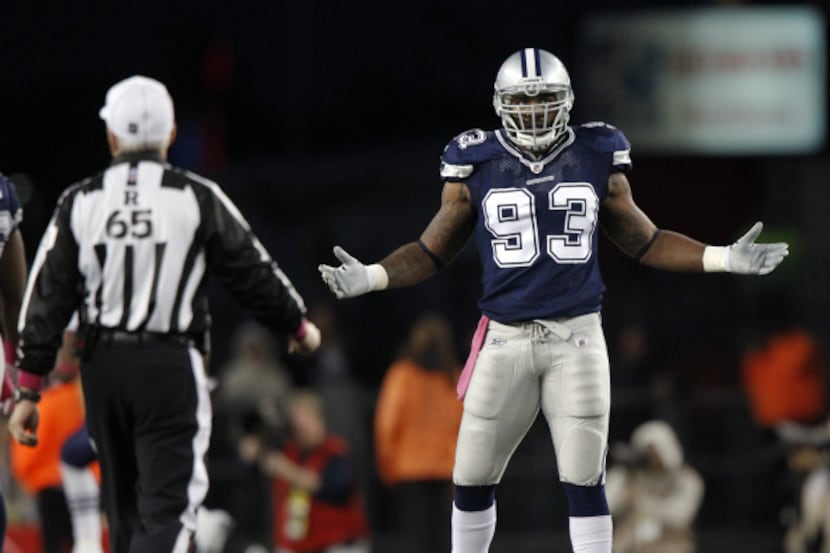 Dallas Cowboys outside linebacker Anthony Spencer (93) questions referee Walt Coleman (65)...