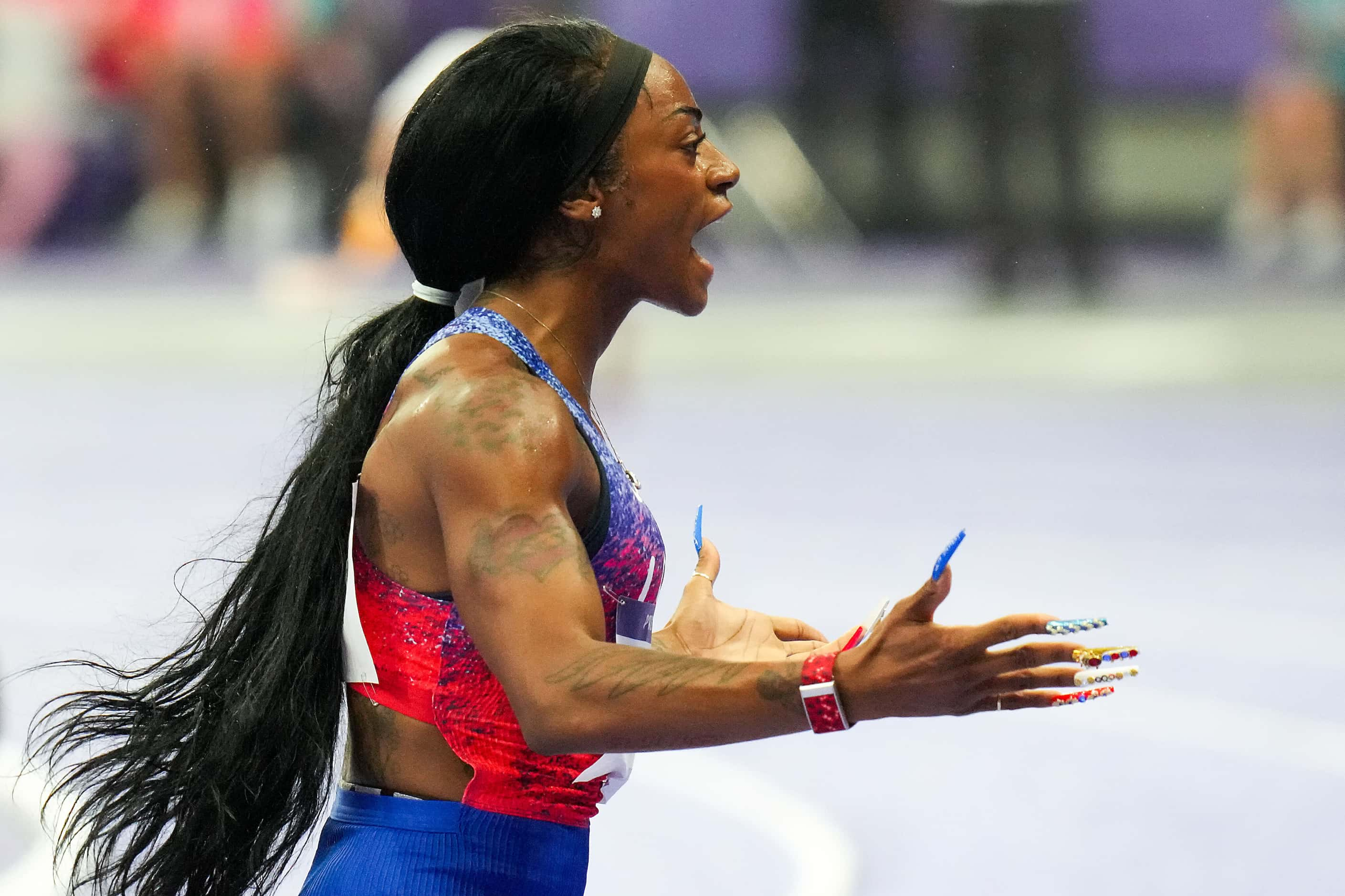 Sha'carri Richardson of the United States celebrates after crossing the finish line to win...