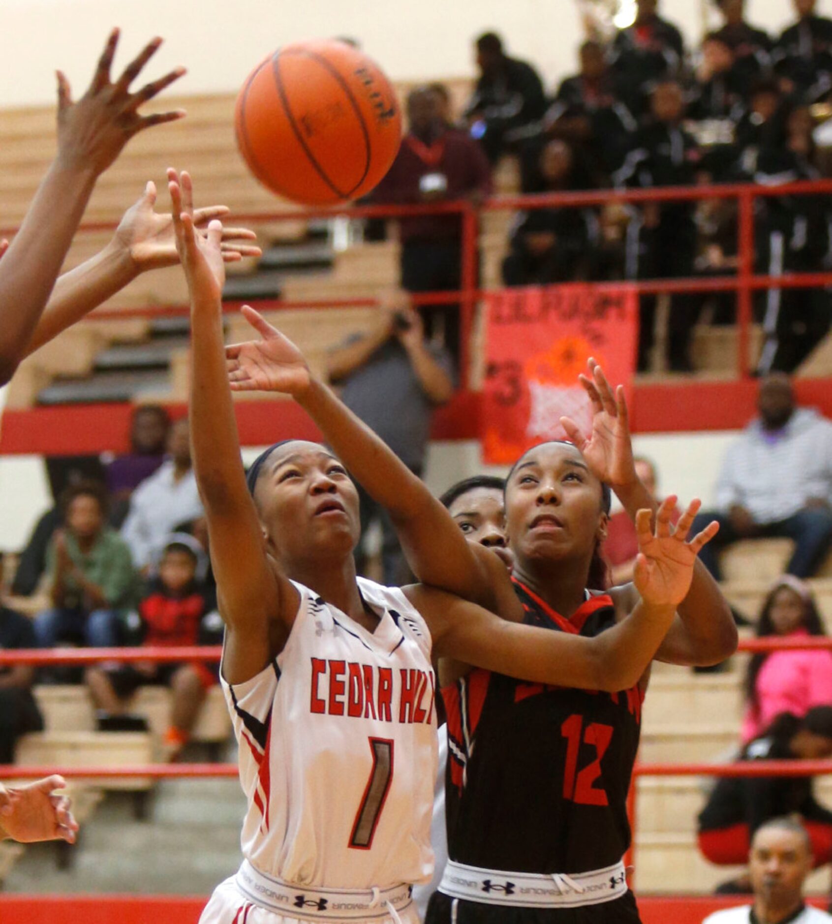 Cedar Hill point guard Dajinae McCarty (1) and South Grand Prairie player Kayla Wells (12)...