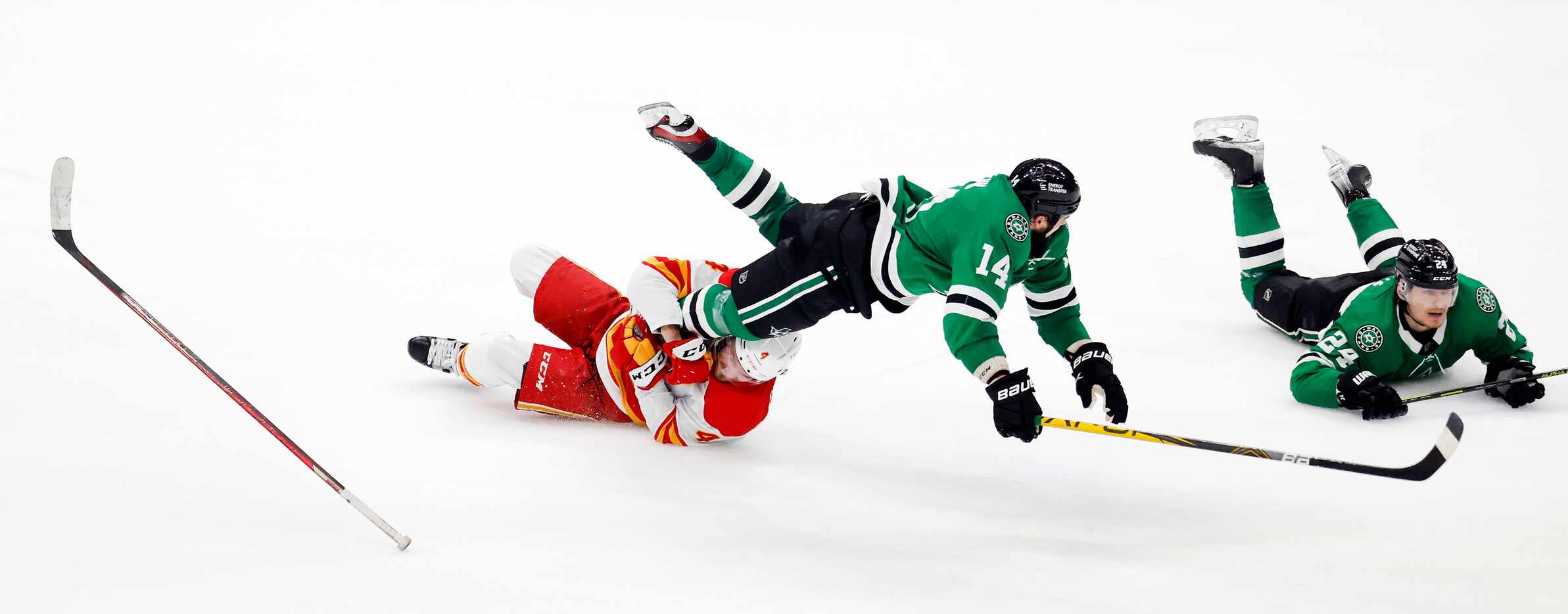 Dallas Stars left wing Jamie Benn (14) collides with Calgary Flames defenseman Rasmus...