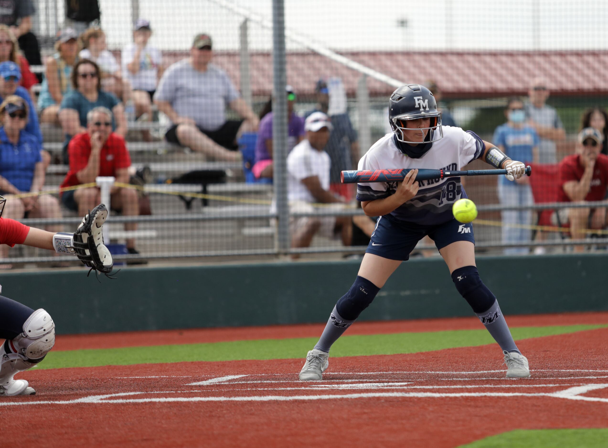 Flower Mound High School player #18, Jordyn Holland, holds back from a bunt during a...