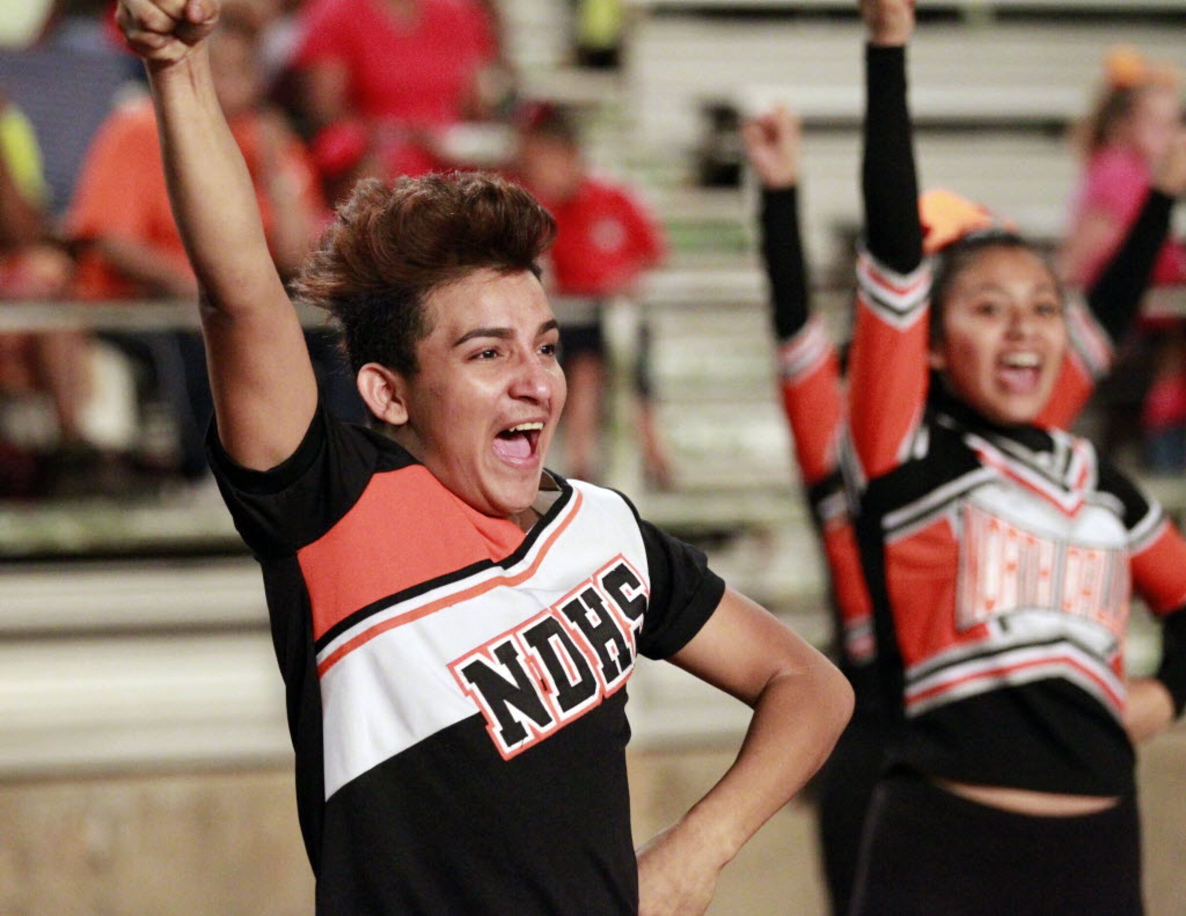 (TXHSFB) North Dallas High cheerleader Carlos Villatoro, 17, a senior, yells during the...