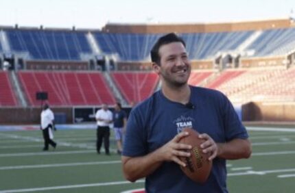  Dallas Cowboys quarterback Tony Romo prepares to throw a pass to fans during the Core Power...