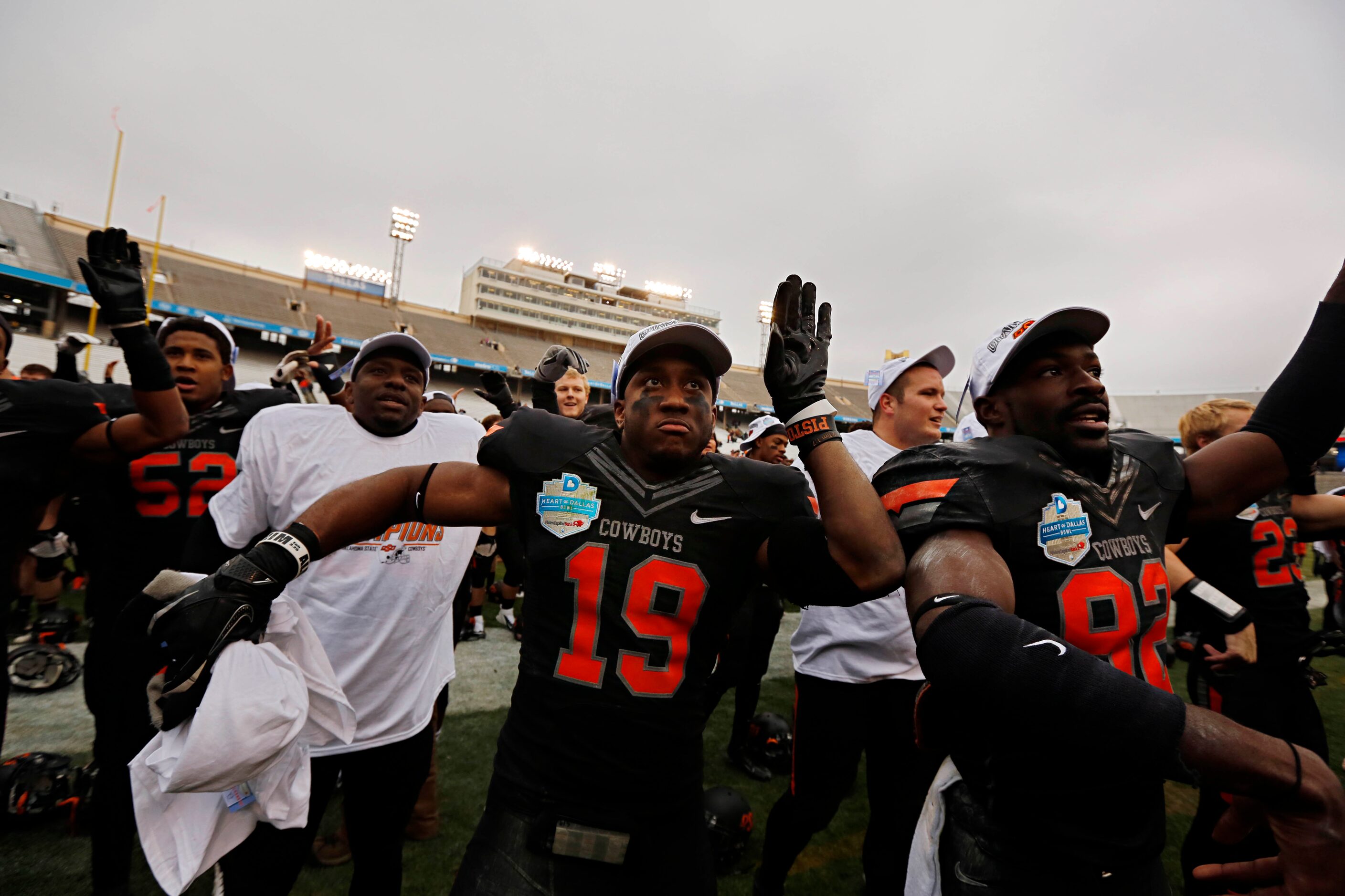 Oklahoma State Cowboys cornerback Brodrick Brown (19) and other players celebrate following...