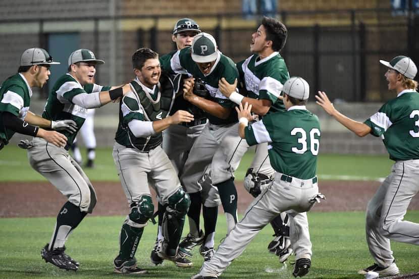 Prosper players swarm relief pitcher Matthew Gonzalez after they defeated Frisco Wakeland,...