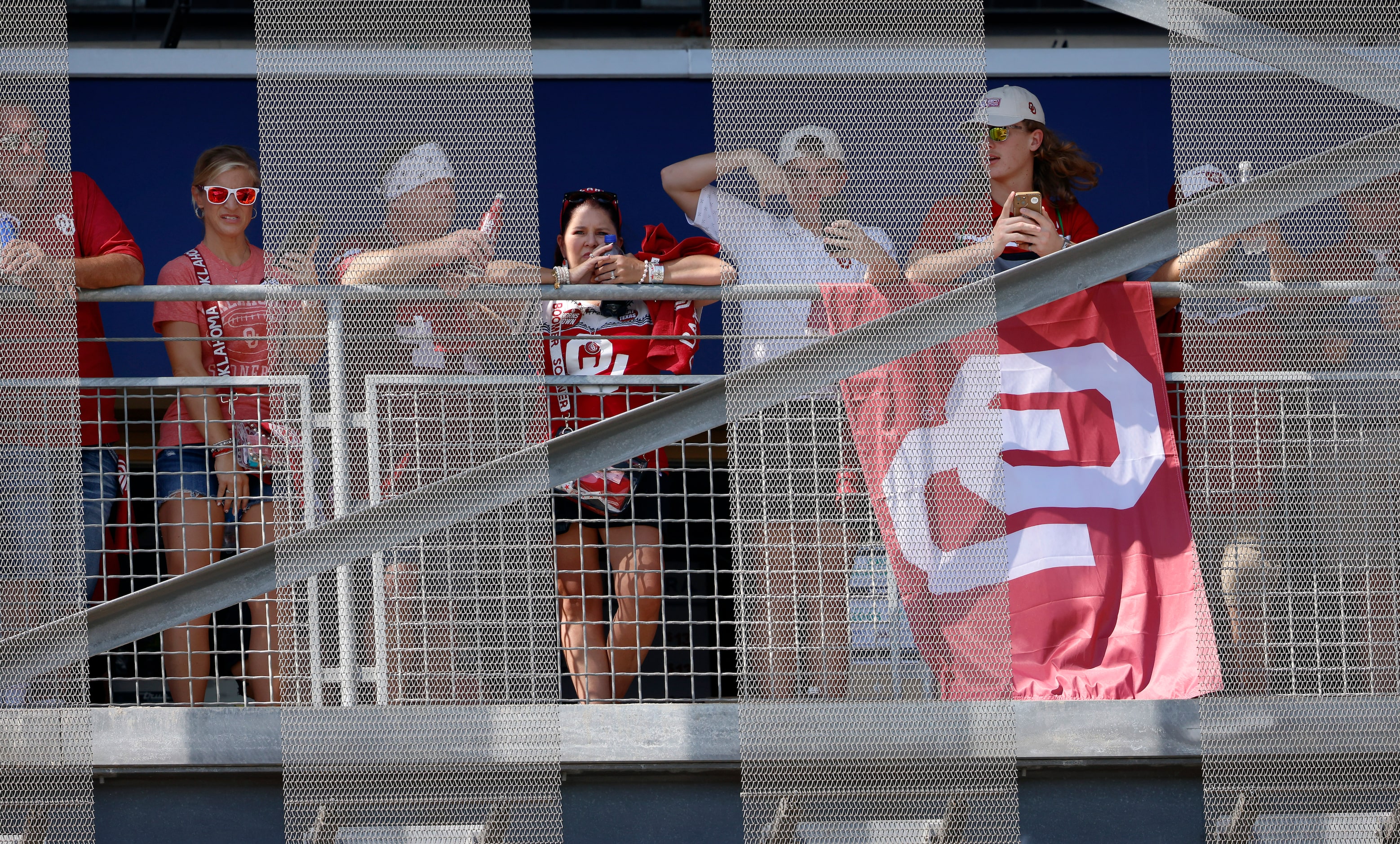 Texas Longhorns and Oklahoma Sooners fans watch team arrivals for the Red River Rivalry...