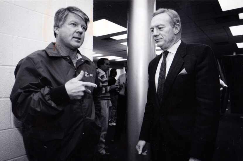 December 10, 1990 - Dallas Cowboys owner Jerry Jones (right) listens to head coach Jimmy...