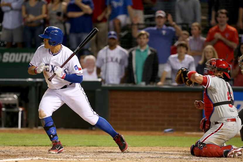 Texas Rangers left fielder Shin-Soo Choo (17) takes a ball four walk-off-walk to beat the...