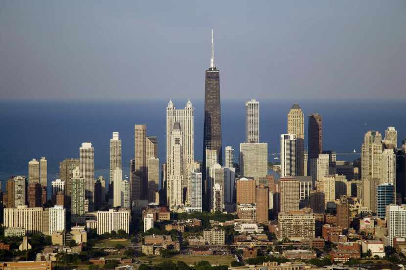 The Chicago skyline, with the distinctive Willis Tower rising above other office buildings....