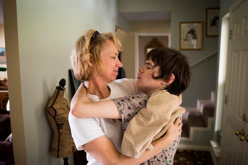 Christy Zartler hugs her daughter Kara after suctioning Kara's stuffy nose on Friday, March...