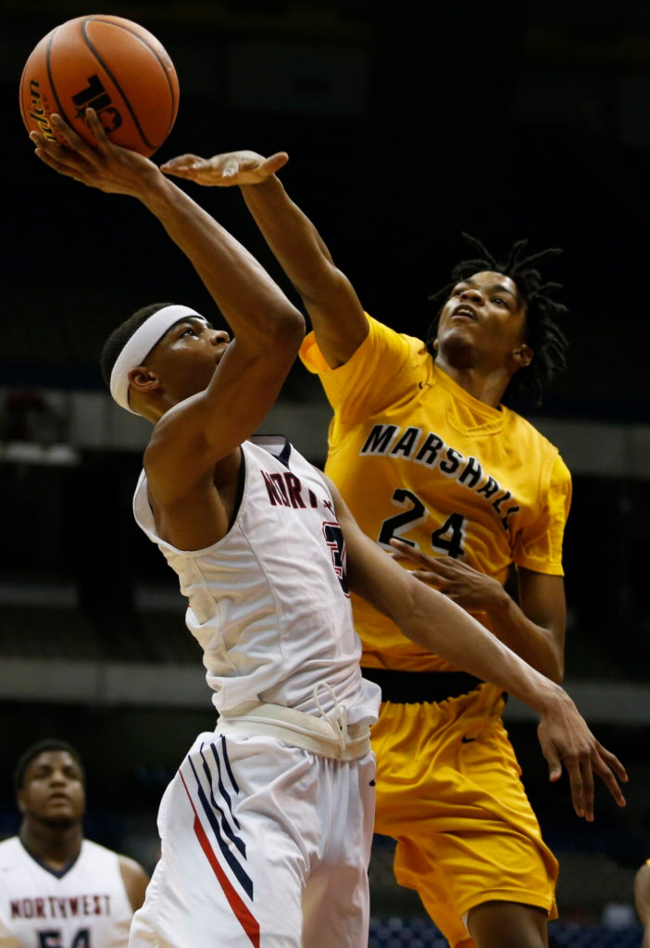 Justin Northwest's Avery Anderson (3) goes to the basket defended by Fort Bend Marshall's...