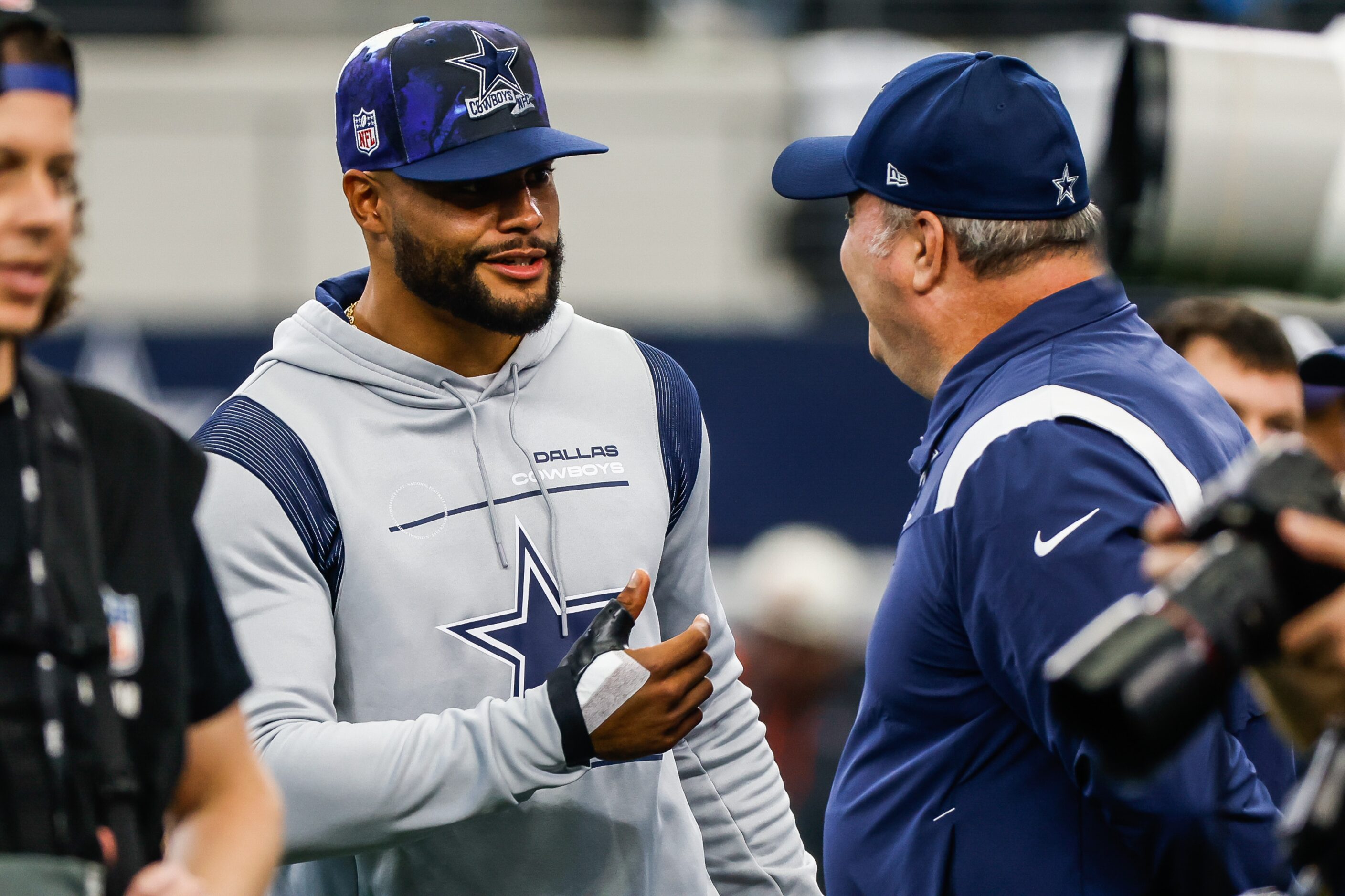 Dallas Cowboys quarterback Dak Prescott (4) talks with head coach Mike McCarthy during...