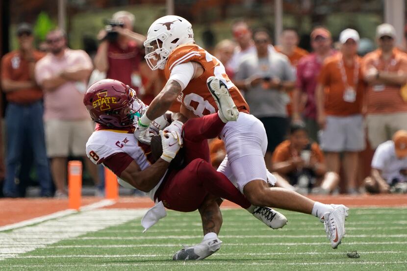 Iowa State wide receiver Xavier Hutchinson (8) is hit by Texas defensive back Jerrin...