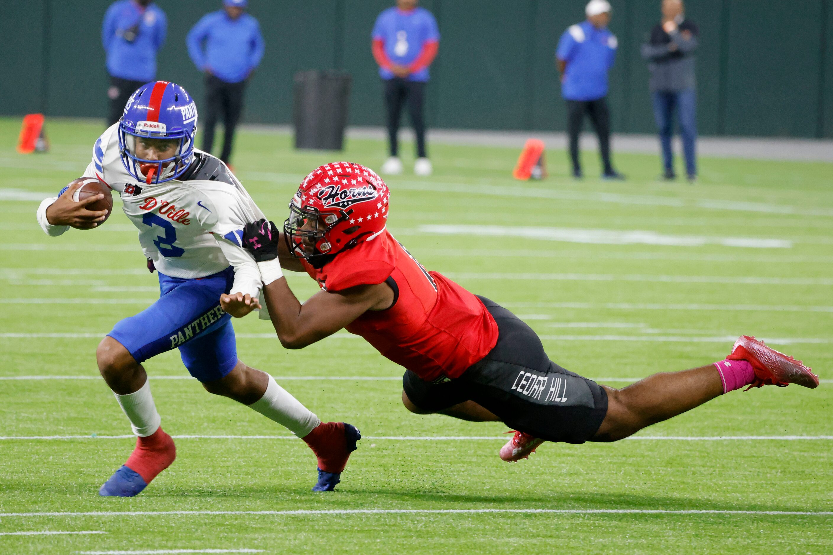 Duncanville quarterback Soloman James (3), gets tackled by Cedar Hill’s Harvey Dyson III,...