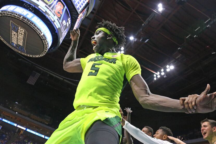 Baylor Bears forward Johnathan Motley (5) celebrates with teammates as time winds down in...