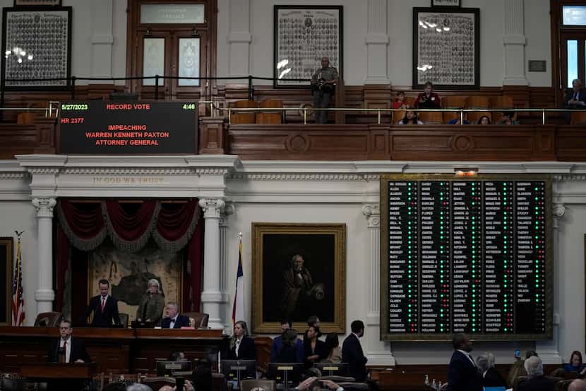 The voting board is lit with a majority of green lights as the house votes to impeach state...