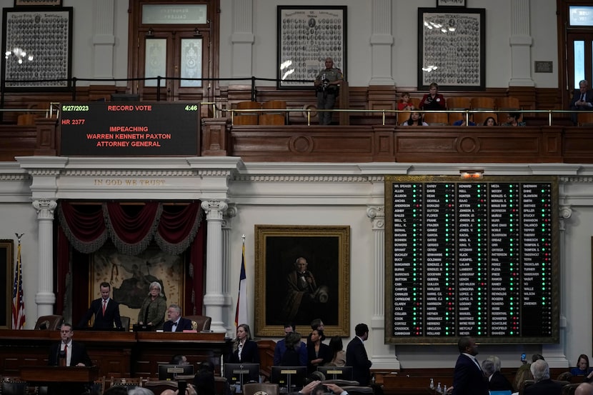 The voting board is lit with a majority of green lights as the Texas House votes to impeach...