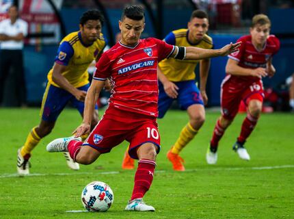 FC Dallas midfielder Mauro Diaz (10) takes a penalty kick resulting in a goal in the 44th...