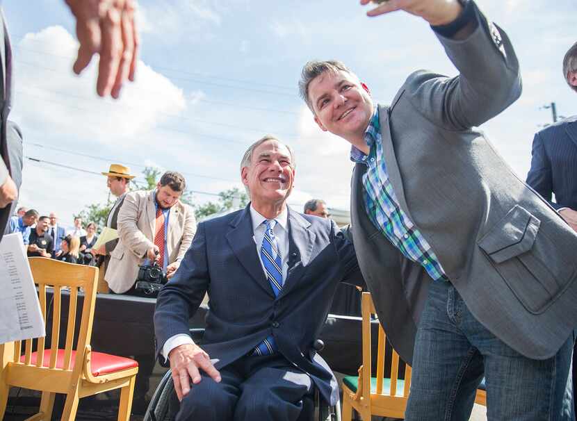Nathaniel Mayfield takes a photo with Governor Greg Abbott after he signed a bill that...