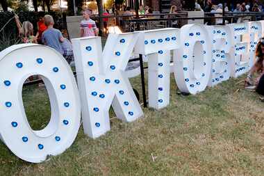 Michelle Torres of Irving sits in front of the Oktoberfest sign during the city of Frisco’s...