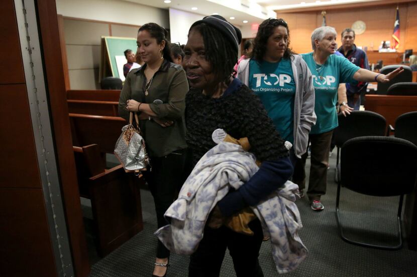 Pearlie Mae Brown, an HMK tenant in West Dallas, leaves the courtroom after a hearing.