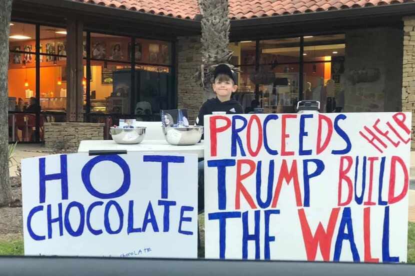 Benton Stevens, 7, of Austin works his hot chocolate stand outside a shopping center to...