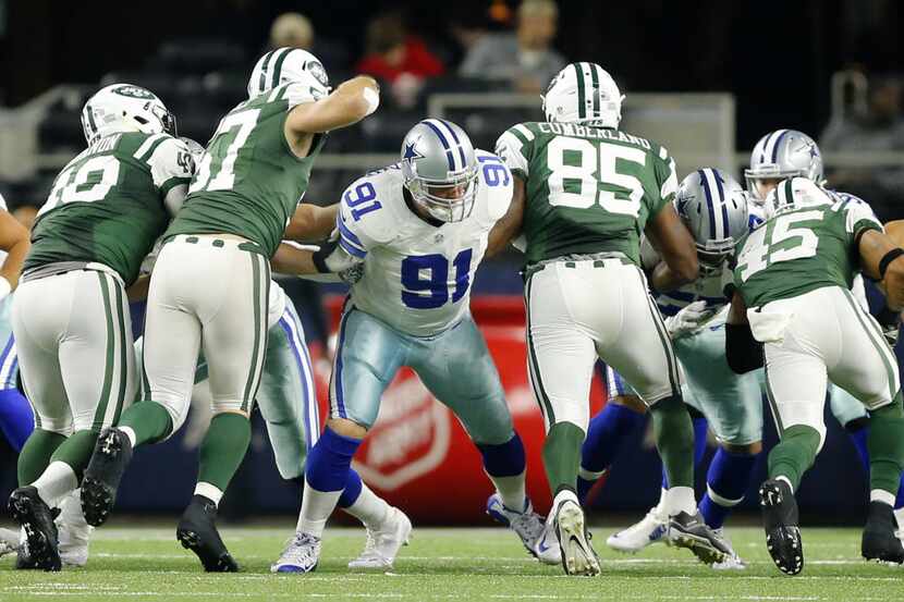 Dallas Cowboys long snapper L.P. LaDouceur (91) tries to stop the New York Jets defensive...