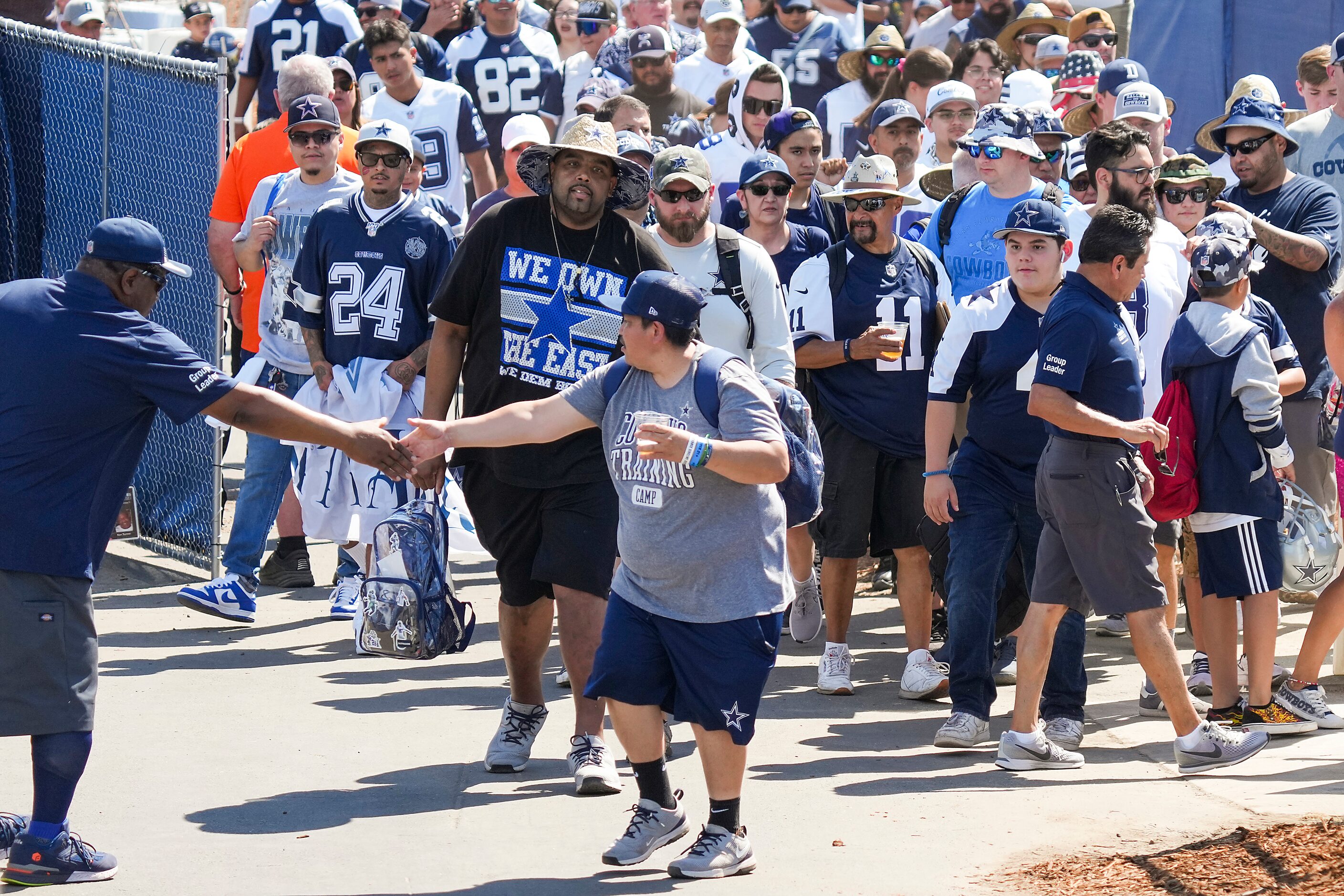 Fans stream into the complex as the gates open for the first practice of the Dallas Cowboys...