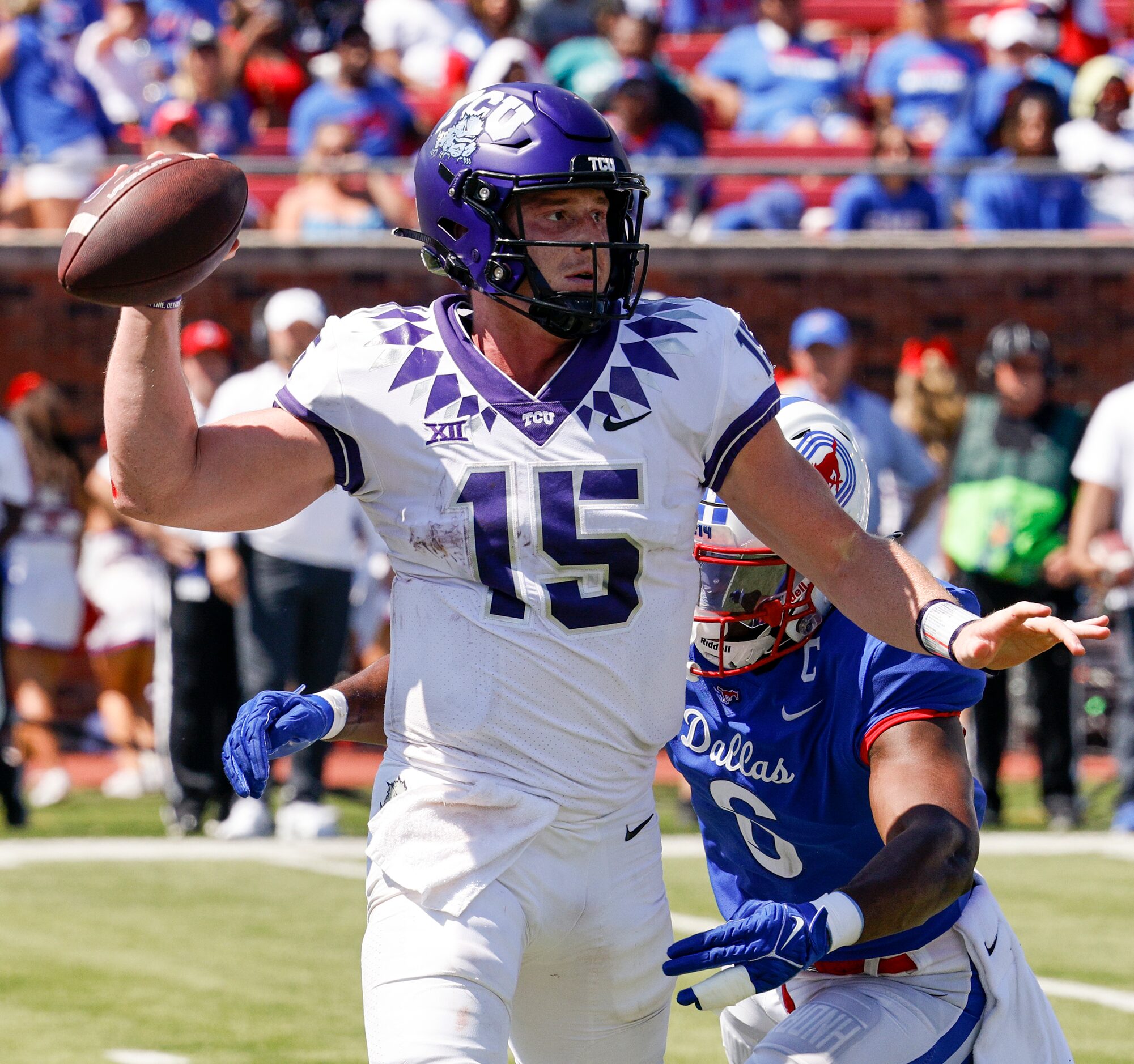 TCU quarterback Max Duggan (15) throws the ball while under pressure from SMU linebacker...