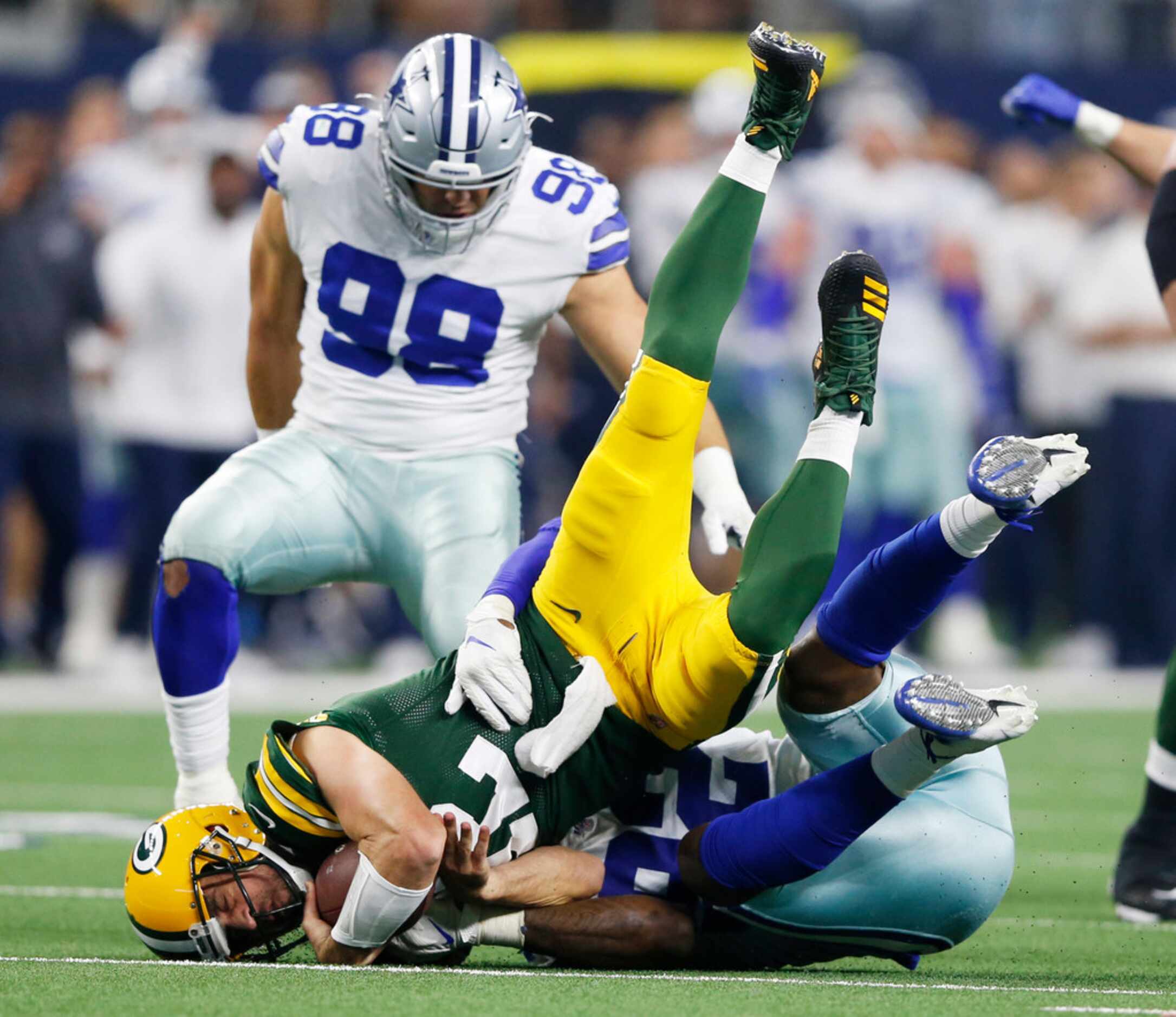 Dallas Cowboys defensive end Dorance Armstrong (92) sacks Green Bay Packers quarterback...